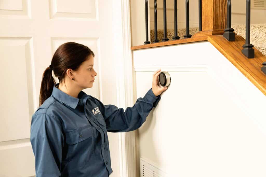 An HVAC technician assessing common heating problems in the winter in a house - Lee Company