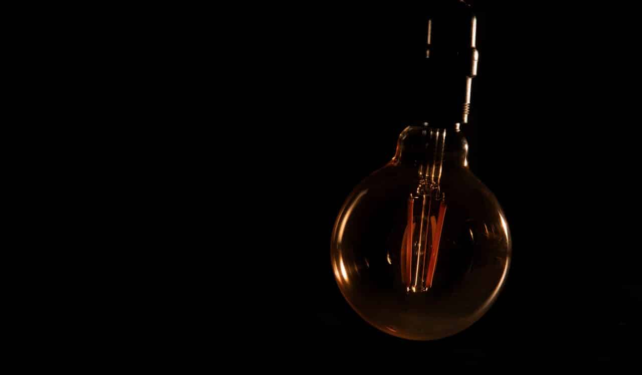 A blackout or power outage represented by a dark lightbulb