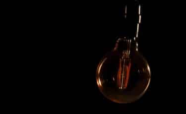 A blackout or power outage represented by a dark lightbulb