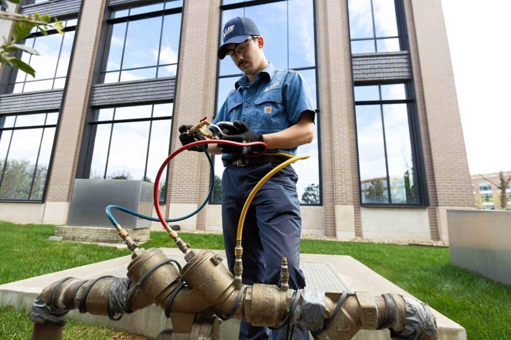 Backflow prevention in commercial buildings being performed by a Lee Company technician