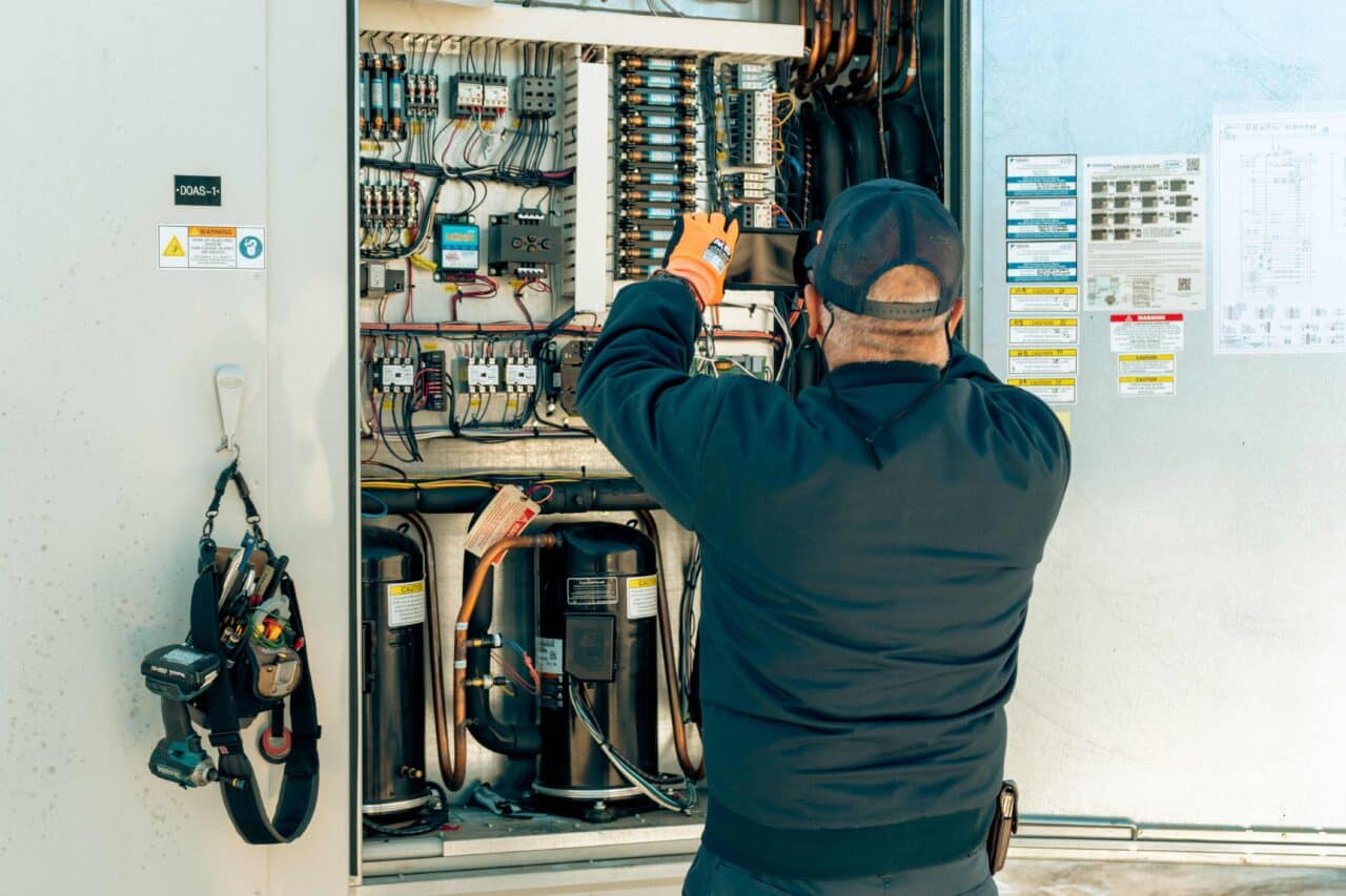 A Lee Company technician performing commercial HVAC troubleshooting