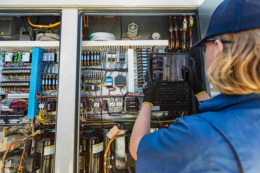 A Lee Company technician performing commercial facility maintenance