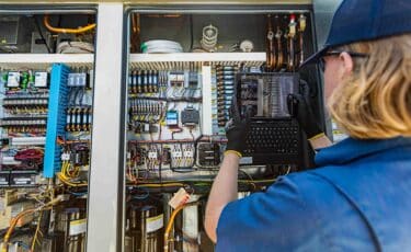 A Lee Company technician performing commercial facility maintenance